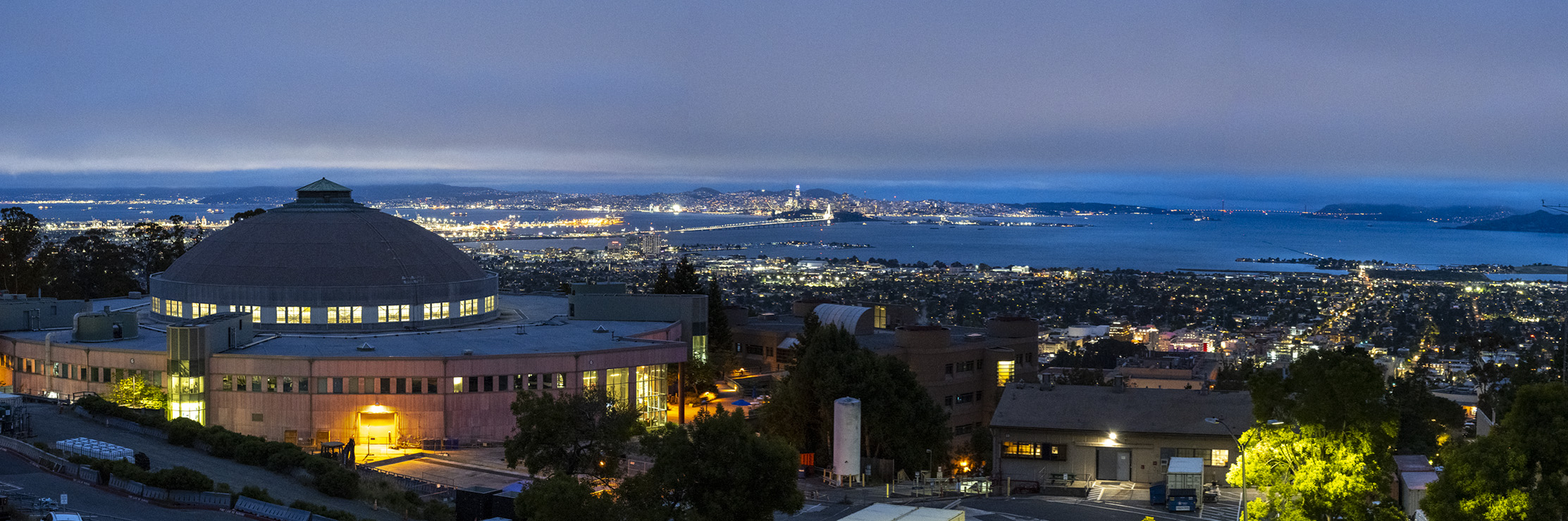 The Advanced Light Source (ALS) dome at night with the bay in the distance.