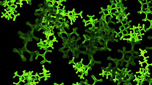 A glowing green light in darkness, depicting a 3D, medically accurate representation of amino acids.