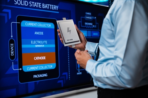 person standing in front of solid state battery display