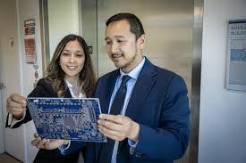 Dana and Daniel looking at at circuit board